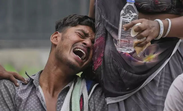 Kalpesh Bhai, whose 14-year-old brother was killed when an Air India plane crashed into a neighborhood, wails outside the autopsy room of a hospital in Ahmedabad, India, Friday, June 13, 2025. (AP Photo/Rafiq Maqbool)