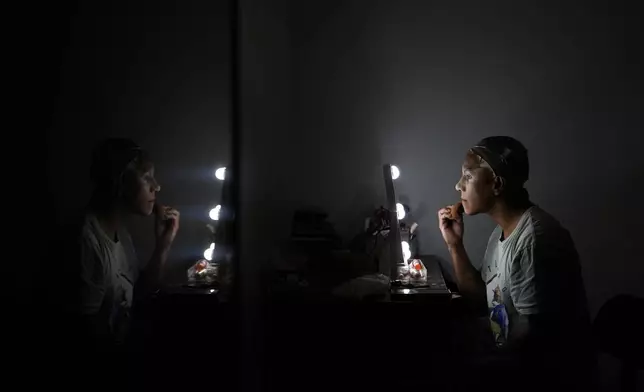 Mari Con Carne applies their makeup before attending Les Miserables at the Kennedy Center in drag, on the night that President Donald Trump and first lady Melania Trump were also in attendance, Wednesday, June 11, 2025, in Washington. (AP Photo/Julia Demaree Nikhinson)