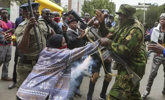 A protester scuffles with the police during a protest over the death in police custody of blogger Albert Ojwang, in Nairobi, Kenya, Thursday, June 12, 2025. (AP Photo/Andrew Kasuku)