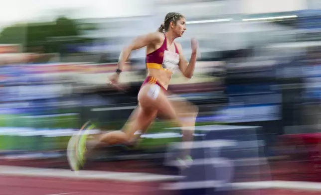 In this image taken with a slow shutter speed, Slovakia's Emma Zapletalová competes in the women's 400-meter hurdle race during the Bislett Games athletics meeting at Bislett Stadium in Oslo, Thursday, June 12, 2025. (Fredrik Varfjell/NTB via AP)