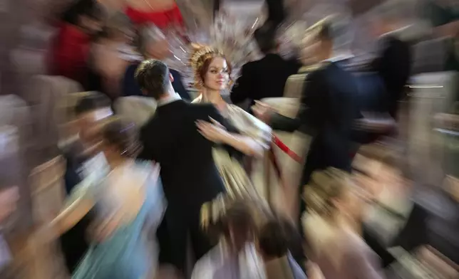 Students dance the waltz during the annual "The Debutantes' Ball," a dance project that unites students from Moscow and St. Petersburg, in the Marble Hall of the Russian Ethnographic Museum in St. Petersburg, Russia, Thursday, June 12, 2025. (AP Photo/Dmitri Lovetsky)