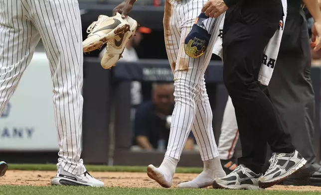 New York Yankees' Jazz Chisholm Jr. walks to the dugout without shoes after scoring during the second inning of a baseball game against the Baltimore Orioles, Sunday, June 22, 2025, in New York. (AP Photo/Pamela Smith)