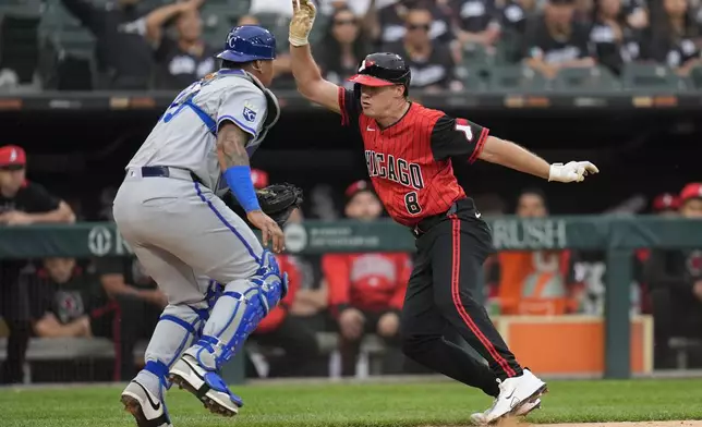 Chicago White Sox's Kyle Teel (8), right, gets tagged out by Kansas City Royals catcher Salvador Perez (13) during the second inning of a baseball game, Friday, June 6, 2025, in Chicago. (AP Photo/Erin Hooley)