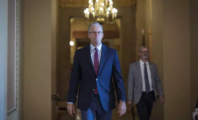 Senate Majority Leader John Thune, R-S.D., walks to the chamber as Senate Republicans work to pass President Donald Trump's big bill of tax breaks, spending cuts by his July Fourth deadline, at the Capitol in Washington, Sunday, June 29, 2025. (AP Photo/J. Scott Applewhite)