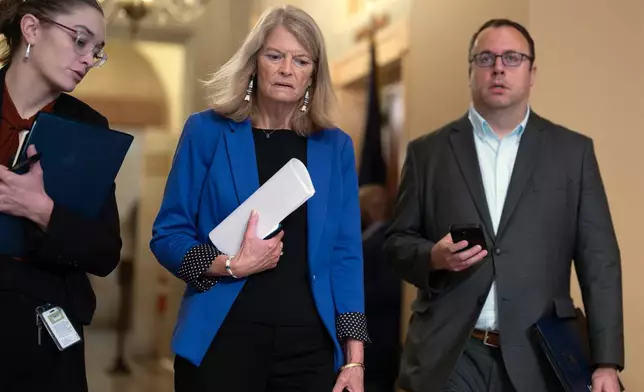 Sen. Lisa Murkowski, R-Alaska, center, a member of the Senate Appropriations Committee, arrives for a closed-door Republican meeting to advance President Donald Trump's sweeping domestic policy bill, at the Capitol in Washington, Friday, June 27, 2025. (AP Photo/J. Scott Applewhite)