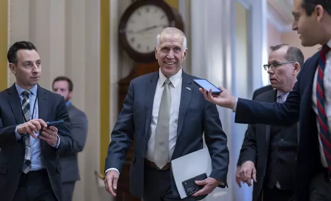 FILE — Sen. Thom Tillis, R-N.C., speaks with reporters as he heads to the chamber during a test vote to begin debate on a border security bill, at the Capitol in Washington, Feb. 7, 2024. (AP Photo/J. Scott Applewhite, File)