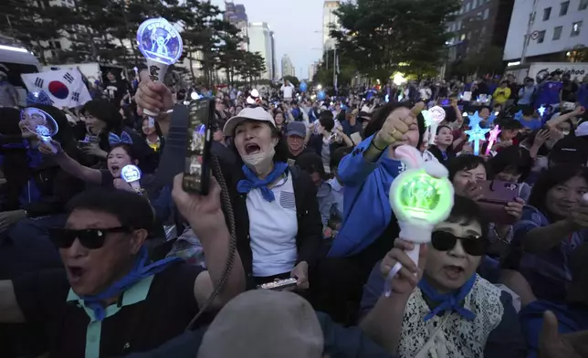 Supporters of South Korea's Democratic Party's presidential candidate Lee Jae-myung, react outside the National Assembly in Seoul, South Korea, Tuesday, June 3, 2025. (AP Photo/Lee Jin-man)