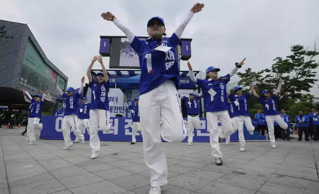 Supporters of South Korea's Democratic Party's presidential candidate Lee Jae-myung perform during a presidential election campaign in Seoul, South Korea, Monday, June 2, 2025. (AP Photo/Ahn Young-joon)