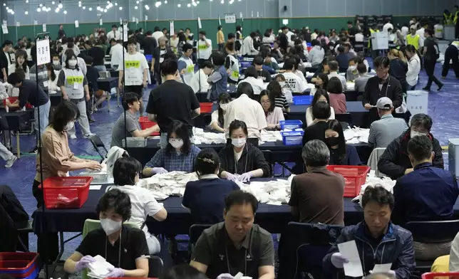 National Election Commission officials sort out ballots for counting at the presidential election in Seoul, South Korea,Tuesday, June 3, 2025. (AP Photo/Ahn Young-joon)