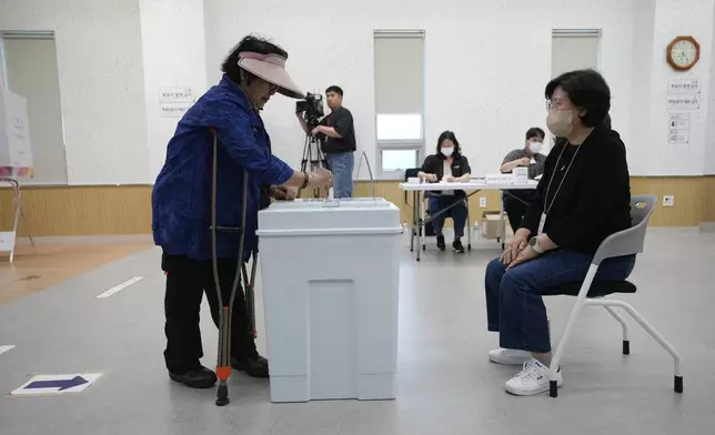 A woman casts her vote for the presidential election at a polling station in Seoul, South Korea, Tuesday, June 3, 2025. (AP Photo/Ahn Young-joon)
