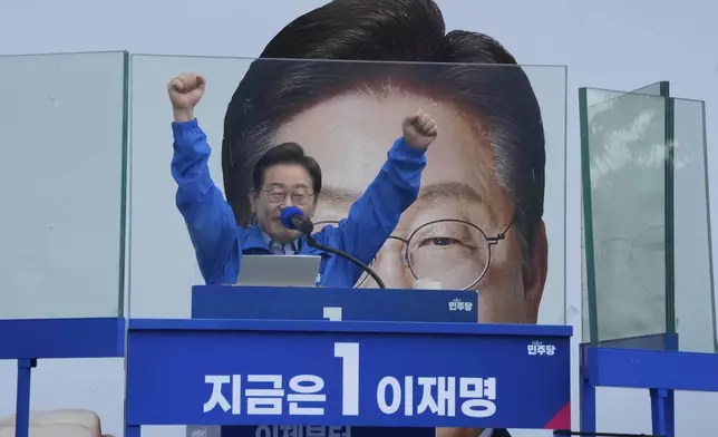 South Korea's Democratic Party's presidential candidate Lee Jae-myung raises his hands during a presidential election campaign in Seoul, South Korea, Monday, June 2, 2025. (AP Photo/Ahn Young-joon)