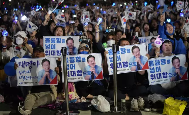 Supporters of South Korea's Democratic Party's presidential candidate Lee Jae-myung, react outside the National Assembly in Seoul, South Korea, Tuesday, June 3, 2025. (AP Photo/Ahn Young-joon)
