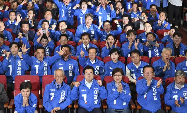 Members of the Democratic Party of Korea watch television coverage of the exit polls for the presidential election at the National Assembly in Seoul, South Korea, Tuesday June 3, 2025. (Jung Yeon-je/Pool via AP)