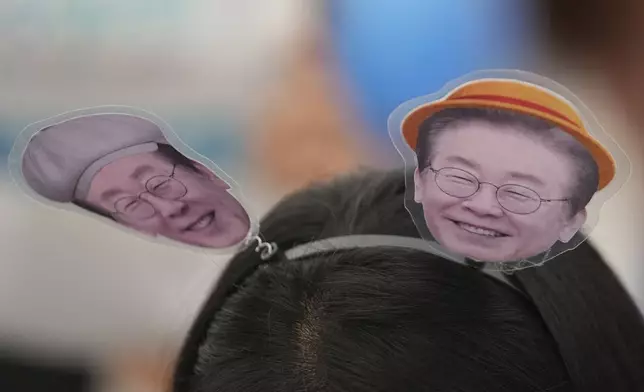 A supporter of South Korea's Democratic Party's presidential candidate Lee Jae-myung, wears a headband with pictures of presidential candidate Lee Jae-myung, during a presidential election campaign in Seoul, South Korea, Monday, June 2, 2025. (AP Photo/Lee Jin-man)