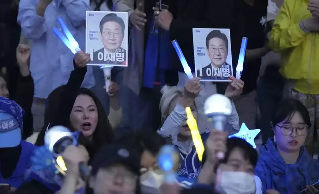 Supporters of South Korea's Democratic Party's presidential candidate Lee Jae-myung, hold pictures of Lee Jae-myung, outside the National Assembly in Seoul, South Korea, Tuesday, June 3, 2025. (AP Photo/Lee Jin-man)