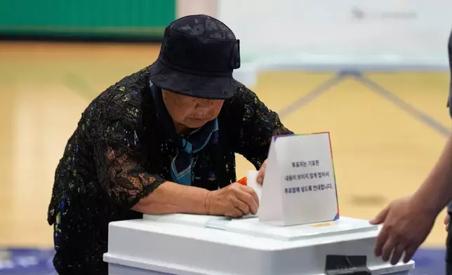 A woman casts her vote for the presidential election at a polling station in Seoul, South Korea, Tuesday, June 3, 2025. (AP Photo/Lee Jin-man)