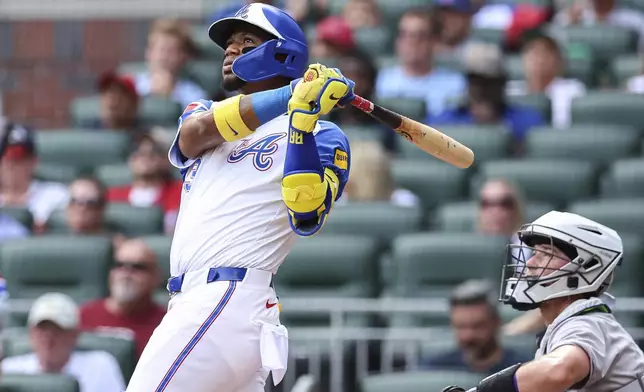 Atlanta Braves' Ronald Acuña Jr. hits a two-run home run in the second inning of a baseball game against the Colorado Rockies, Saturday, June 14, 2025, in Atlanta. (AP Photo/Colin Hubbard)