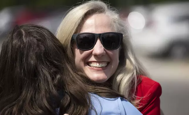 Democratic gubernatorial candidate Abigail Spanberger greets people ahead of a press conference in front of a new housing development in Sandston, Va., Friday, June 6, 2025. (Mike KRopf/Richmond Times-Dispatch via AP)
