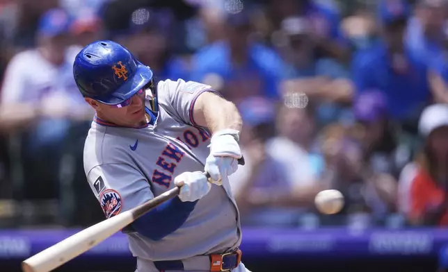 New York Mets' Pete Alonso swings at a pitch form Colorado Rockies starting pitcher Chase Dollander in the first inning of a baseball game, Sunday, June 8, 2025, in Denver. (AP Photo/David Zalubowski)
