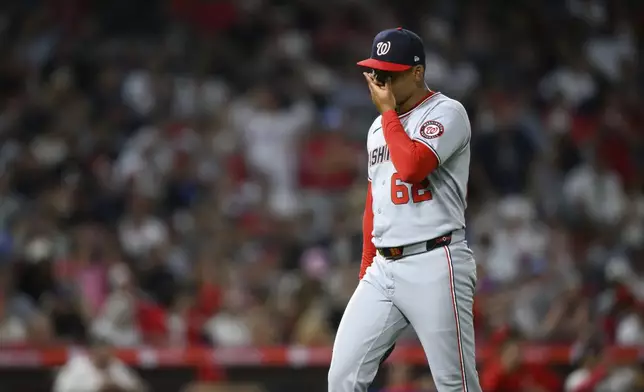 Washington Nationals pitcher Eduardo Salazar reacts after giving up four runs during the seventh inning of a baseball game against the Los Angeles Angels, Saturday, June 28, 2025, in Anaheim, Calif. (AP Photo/William Liang)