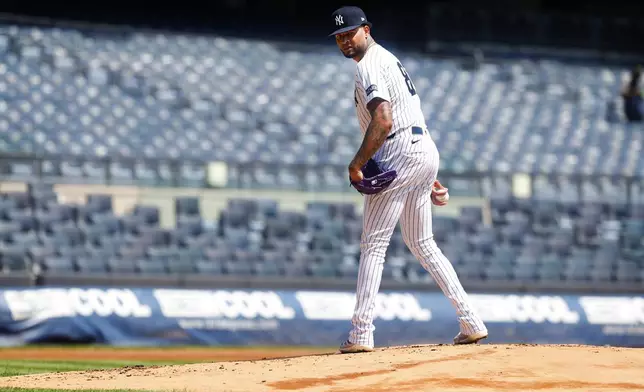 New York Yankees' Luis Gil looks to first before throwing during live batting practice before a baseball game between the New York Yankees and the Baltimore Orioles, Saturday, June 21, 2025, in New York. (AP Photo/Noah K. Murray)