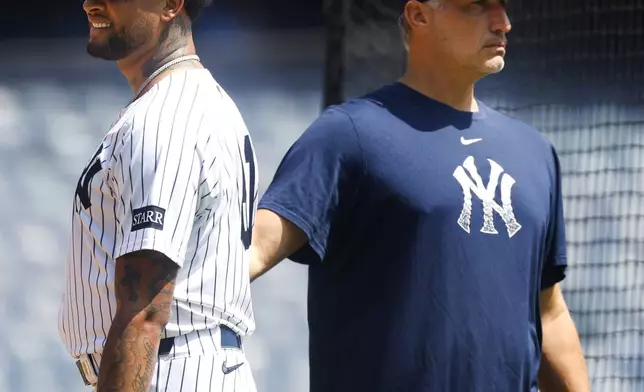 New York Yankees' Luis Gil, left, and Andy Pettitte, right, look on during live batting practice before a baseball game between the New York Yankees and the Baltimore Orioles, Saturday, June 21, 2025, in New York. (AP Photo/Noah K. Murray)