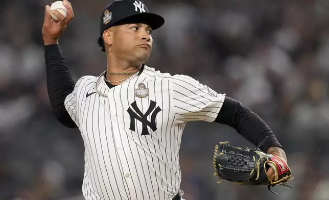 FILE - New York Yankees pitcher Luis Gil throws against the Los Angeles Dodgers during the first inning in Game 4 of the baseball World Series, Tuesday, Oct. 29, 2024, in New York. (AP Photo/Ashley Landis, File)