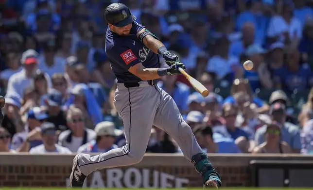 Seattle Mariners' Cal Raleigh hits a two-run home run during the seventh inning of a baseball game against the Chicago Cubs, Friday, June 20, 2025, in Chicago. (AP Photo/Erin Hooley)