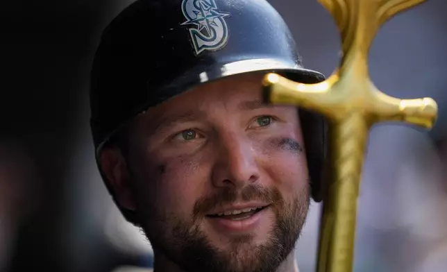 Seattle Mariners' Cal Raleigh holds the "home run trident" after hitting a two-run a home run during the seventh inning of a baseball game against the Chicago Cubs, Friday, June 20, 2025, in Chicago. (AP Photo/Erin Hooley)