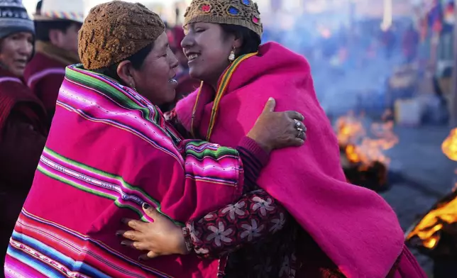 Indigenous people embrace during a celebration of the Andean New Year 5533 marking the Southern Hemisphere's winter solstice, in El Alto, Bolivia, Saturday, June 21, 2025. (AP Photo/Juan Karita)