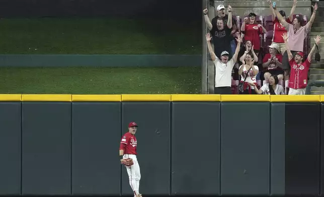 Cincinnati Reds' TJ Friedl reacts after catching a fly ball at the wall to end the game in the ninth inning of a baseball game against the Milwaukee Brewers, Tuesday, June 3, 2025, in Cincinnati. (AP Photo/Kareem Elgazzar)
