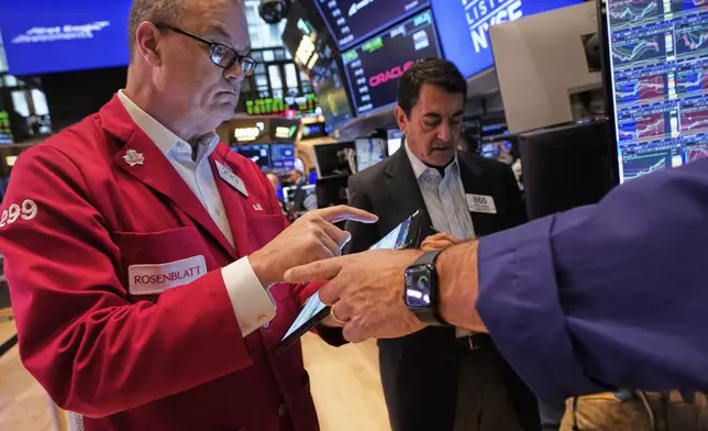 Traders William Lawrence, left, and Mark Mueller work on the floor of the New York Stock Exchange, Thursday, May 29, 2025. (AP Photo/Richard Drew)