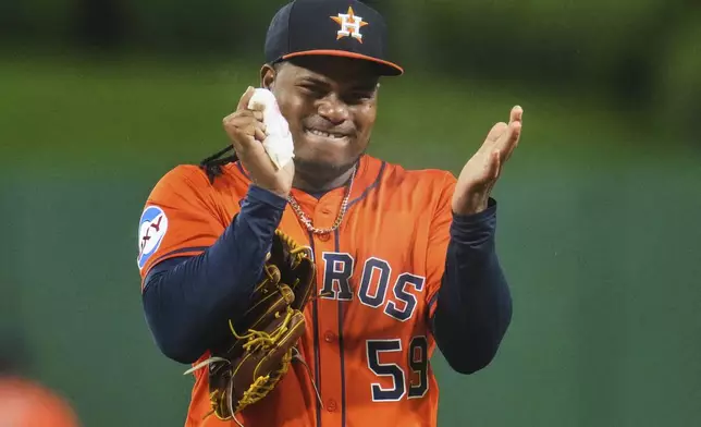 Houston Astros pitcher Framber Valdez gets rosin on his hand before delivering a pitch during the first inning of a baseball game against the Pittsburgh Pirates in Pittsburgh, Thursday, June 5, 2025. (AP Photo/Gene J. Puskar)