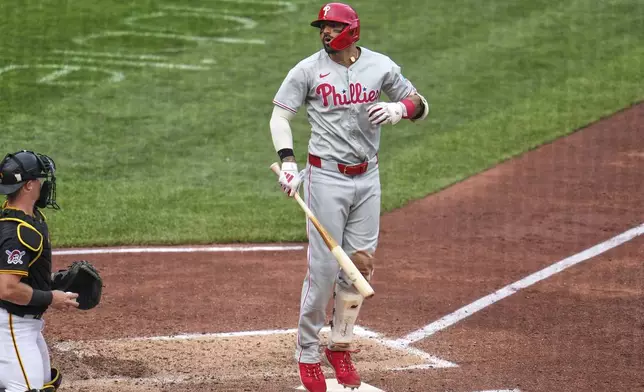 Philadelphia Phillies' Nick Castellanos, center, reacts to a called third strike on a pitch by Pittsburgh Pirates pitcher Isaac Mattson during the seventh inning of a baseball game in Pittsburgh, Saturday, June 7, 2025. (AP Photo/Gene J. Puskar)