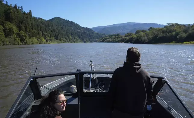 Yurok Tribe members Tiana Williams-Claussen, left, and Morgan Clayburn make their way to Blue Creek while traveling on the Klamath River, Thursday, Sept. 19, 2024, in Humboldt County, Calif. (AP Photo/Godofredo A. Vásquez)