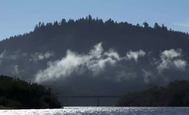 Highway 101 is seen in the distance while traveling on the Klamath River, Thursday, Sept. 19, 2024, in Klamath, Calif. (AP Photo/Godofredo A. Vásquez)