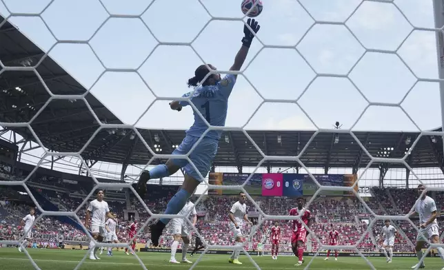 Bayern Munich's Kingsley Coman, center right, heads the ball past Auckland City's Conor Tracey to score the first goal during the Club World Cup group C soccer match between Bayern Munich and Auckland City in Cincinnati, Sunday, June 15, 2025. (AP Photo/Jeff Dean)
