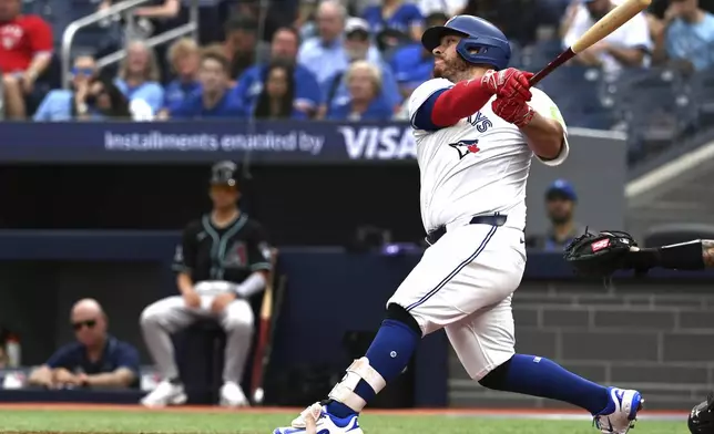 Toronto Blue Jays' Alejandro Kirk hits a solo home run against the Arizona Diamondbacks in second-inning baseball game action in Toronto, Thursday, June 19, 2025. (Jon Blacker/The Canadian Press via AP)