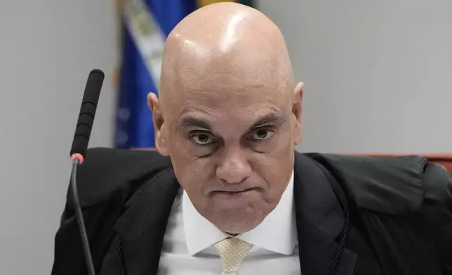 Brazilian Supreme Court Judge Alexandre de Moraes holds a trial for those charged in an alleged coup plot to keep former President Jair Bolsonaro in office after his 2022 election defeat, in Brasilia, Brazil, Tuesday, June 10, 2025. (AP Photo/Eraldo Peres)