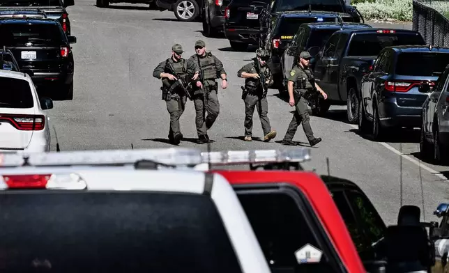 Police and fire crews respond to a shooting and fire on Canfield Mountain in Coeur d'Alene, Idaho, Sunday, June 29, 2025. (Kathy Plonka/The Spokesman-Review via AP)