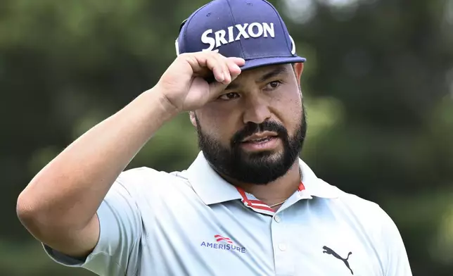 J. J. Spaun tips his cap as he is introduced for the first round of the Travelers Championship golf tournament at TPC River Highlands in Cromwell, Conn., Thursday, June 19, 2025. (AP Photo/Jessica Hill)