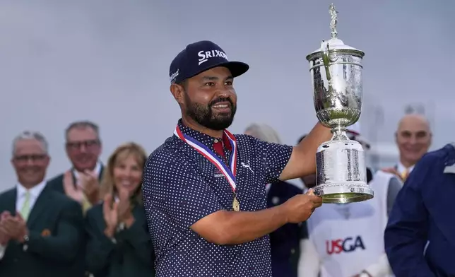 J.J. Spaun celebrates with the trophy after winning the U.S. Open golf tournament at Oakmont Country Club Sunday, June 15, 2025, in Oakmont, Pa. (AP Photo/Carolyn Kaster)