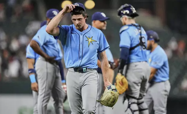 Tampa Bay Rays starter Ryan Pepiot, foreground, leaves the mound during a pitching substitution in the second inning of a baseball game against the Baltimore Orioles, Friday, June 27, 2025, in Baltimore. (AP Photo/Stephanie Scarbrough)