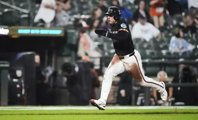 Baltimore Orioles' Ramon Laureano advances toward home plate to score on a throwing error by Tampa Bay Rays catcher Danny Jansen during the third inning of a baseball game, Friday, June 27, 2025, in Baltimore. (AP Photo/Stephanie Scarbrough)