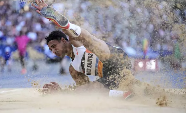 Almir dos Santos, of Brazil, lands an attempt in the men triple jump during the Meeting de Paris Diamond League athletics meet at Stade Charlety in Paris, Friday, June 20, 2025. (AP Photo/Thibault Camus)