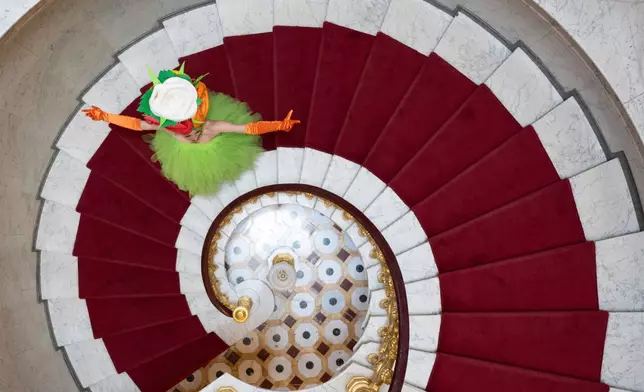 An actress dressed as a flower girl poses on the sidelines of a press conference for the Dresden Castle Night at Albrechtsberg Palace in Dresden, Germany, Wednesday June 18, 2025. (Sebastian Kahnert/dpa via AP)