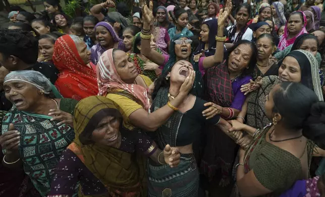 Family members and relatives of Akash Patni, victim of the Air India plane crash, grieve during his funeral procession in Ahmedabad, India, Tuesday, June 17, 2025. (AP Photo/Ajit Solanki)