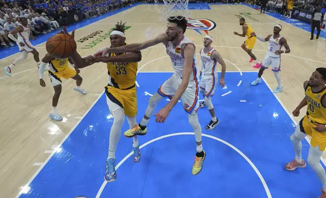 Indiana Pacers center Myles Turner (33) battles Oklahoma City Thunder forward Chet Holmgren (7) for the rebound during the first half of Game 5 of the NBA Finals basketball series, Monday, June 16, 2025, in Oklahoma City. (AP Photo/Nate Billings)