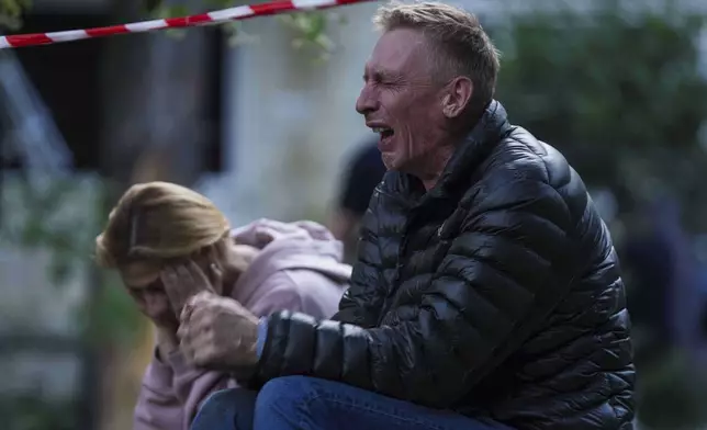 A father cries as his son is under the rubble of a multi-storey residential house destroyed by a Russian strike in Kyiv, Ukraine, on Tuesday, June 17, 2025. (AP Photo/Evgeniy Maloletka)