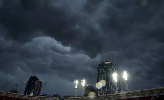 Dark storm clouds move in over Great American Ball Park during a weather delay before a baseball game between the Cincinnati Reds and the Minnesota Twins, Wednesday, June 18, 2025, in Cincinnati. (AP Photo/Carolyn Kaster)